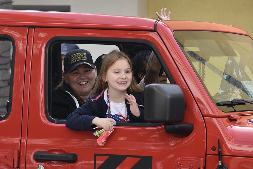 Army veteran Amanda Kraft and her daughter Emma Green, 6, ride in a jeep driven by Maria Guardado-Villagran. The vehicle honors Guardado's friend Jonathan Winterbottom, who was killed in Iraq in 2007.