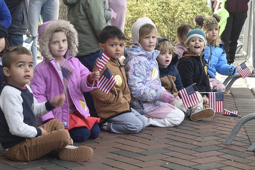 Students from the Early Care Center at First United Methodist Church Of Sarasota watch the parade.