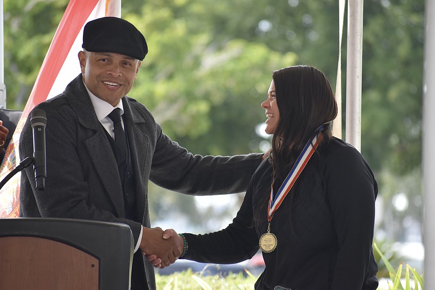 Carlos Moreira presents Jessica Hughes, female veteran of the year, with a medal.