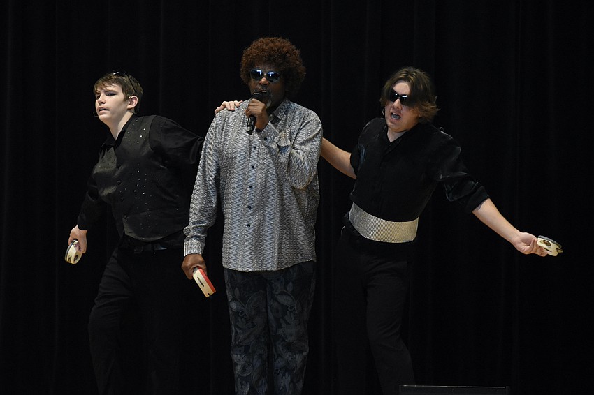 Freshman Jaxon Miklavic, instructor William Coleman, and senior Colten Zwizinski perform 