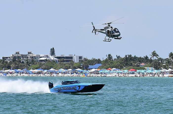 The T/S Motorsports / Marine Technology boat piloted by Taylor Scism of Missouri and Johnny Tomlinson of North Miami, Florida passes crowds of spectators on the beach.