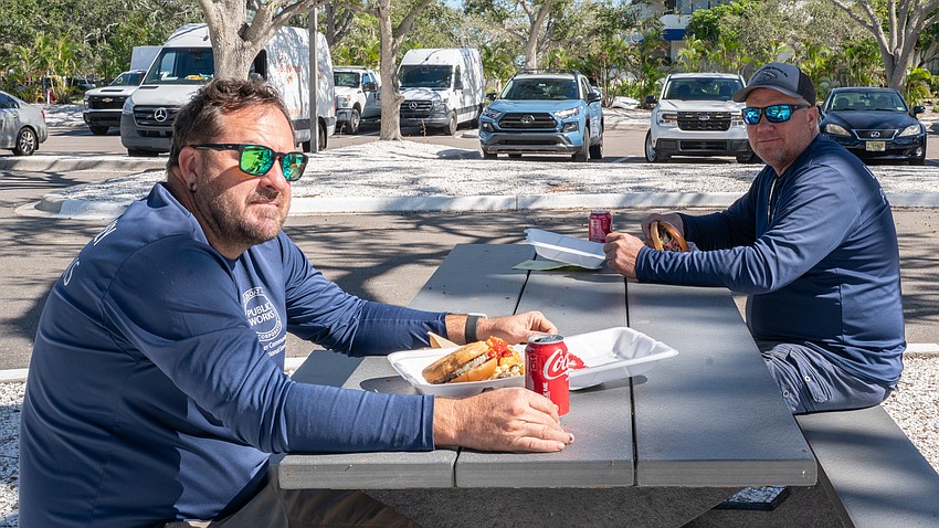 Public Works employees Brad Sicard and Jeff Jackson prepare to dig in at Rotary Club of Longboat Key’s Food for Gratitude event where all town employees received free lunch to recognize their hard work after dual hurricanes in 2024.