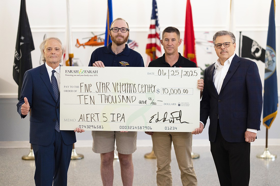 The donation to Five STAR Veterans Center from a previous fundraising partnership between the Farah & Farah law firm and Veterans United Craft Brewery. From left, Farah & Farah founder Eddie Farah, Veterans United Craft Brewery Sales Manager Jeremy Lawson, Five STAR Veterans Center CEO John Bear and Farah & Farah partner Chuck Farah.