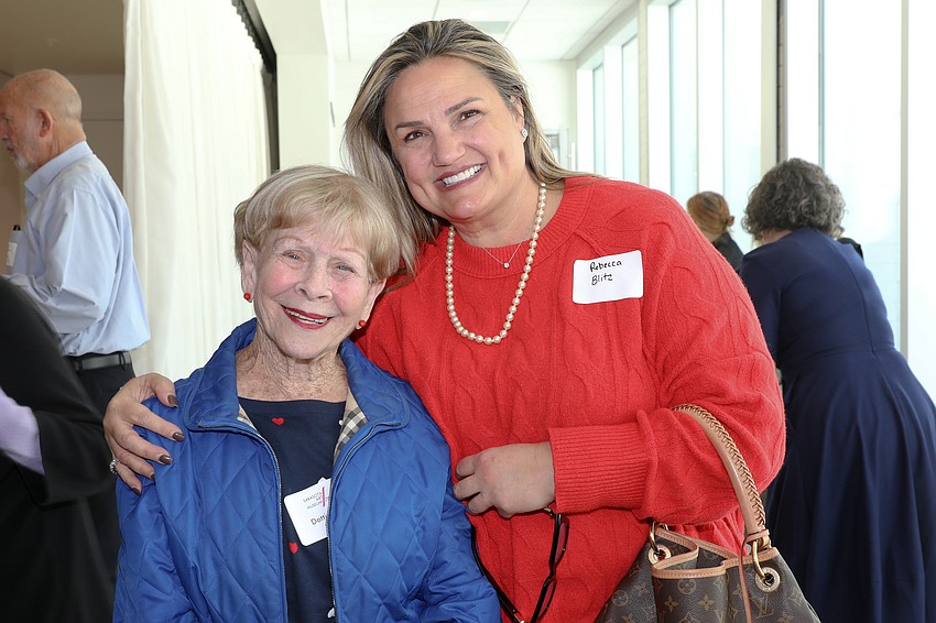 Dottie Garner shakes off the cold with a warm hug from Rebecca Blitz.