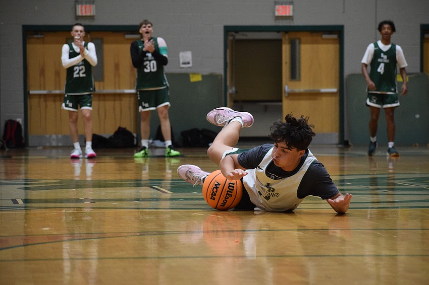 Junior Patrick Johnston dives after a loose ball during a Nov. 12 practice. He's one of several newcomers for the Mustangs in the 2025-26 season.