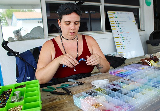 Sarasota Ski-A-Rees sound technician Madison Ditmars demonstrates how she makes the crab figurines she offers by donation to support the group in its ongoing recovery from last year's hurricanes.