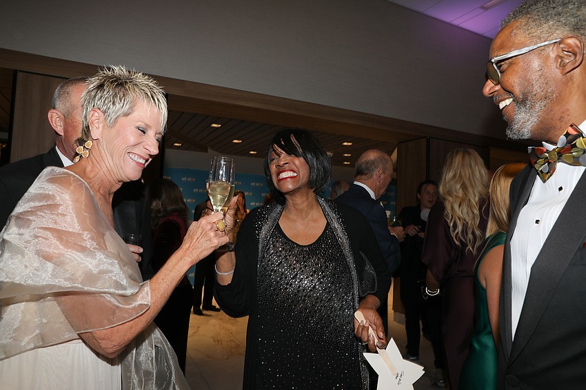 It's a champagne toast with Pam Beauchamp, Denise and Del Cotton.