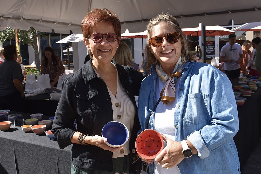 Palmetto's JoAnne Haig and Janelle Clarke have almost decided on the bowls they'll take home, but Haig wants one more walk around the table first.