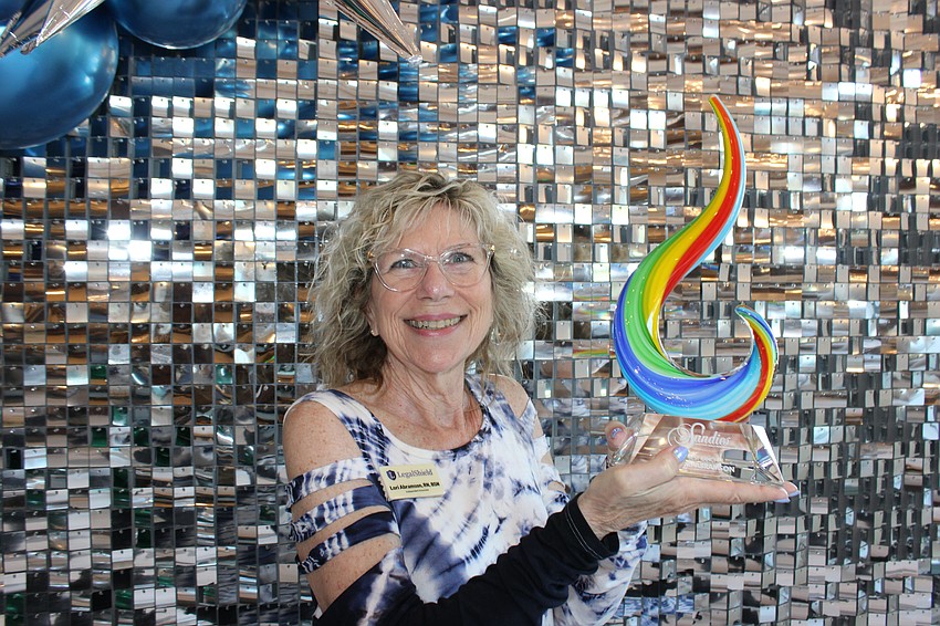 Lori Abramson of LegalShield is happy to show off her Sandies award for Best Rancher Nov. 14 at the Grove in Lakewood Ranch.