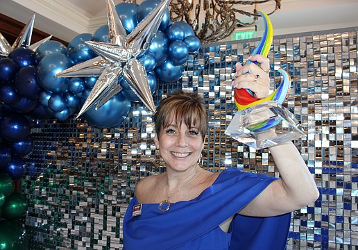 Shawna Hicks-Cranston of PostNet raises her Sandies award for the Community Champion category. The annual Sandies was held by the Lakewood Ranch Business Alliance Nov. 14 at the Grove in Lakewood Ranch.