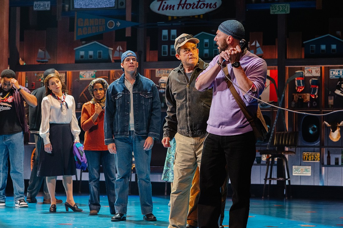 Anxious travelers are desperate to contact loved ones after they are stranded in Gander, Newfoundland, in Asolo Rep's production of "Come From Away."