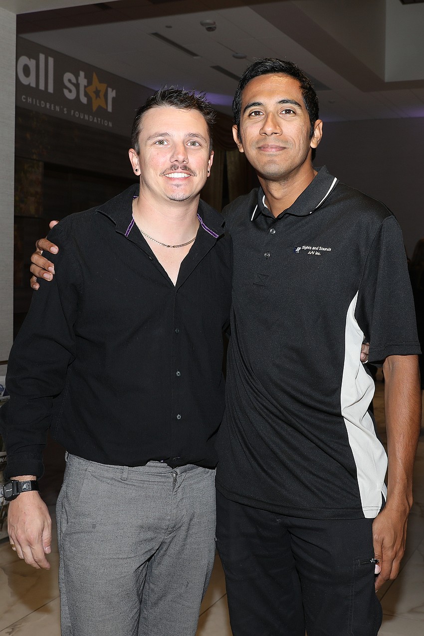 Kyle Baker and Nicholas Libreros stop for a quick photo outside the ballroom.