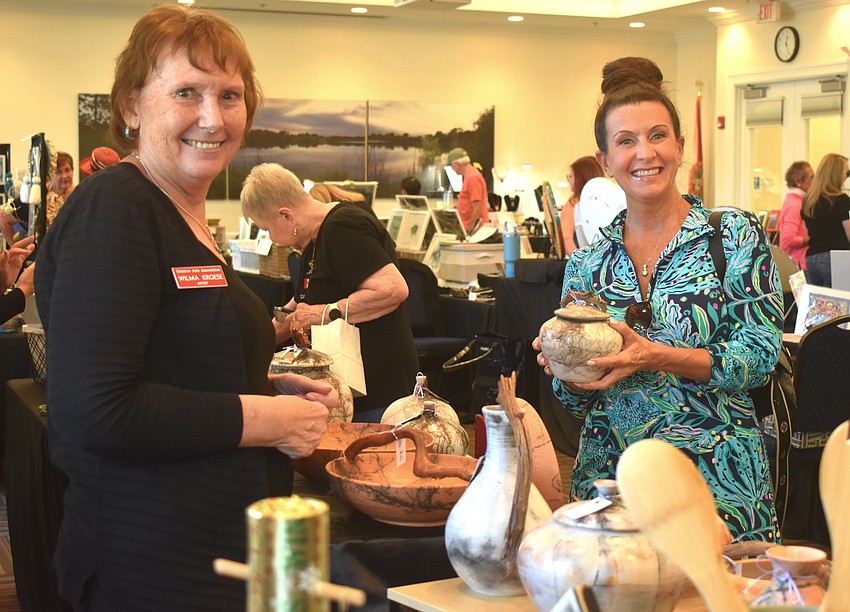 WKP Pottery's Wilma Kroese visits with Mimi Enos, a client she has for her other business WK Sewing.