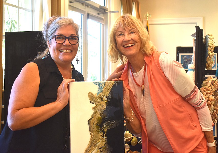 Patty Notarianni sells an acrylic painting to Rosedale's Ruth Anderson. Anderson said the lovely colors and contemporary style caught her eye.