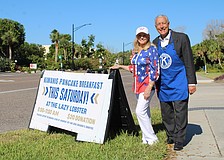 Phyllis Black and Andrew Vac flag down hungry diners to join the Kiwanis Club of Longboat Key's pancake breakfast fundraiser on Nov. 15 at the Lazy Lobster.