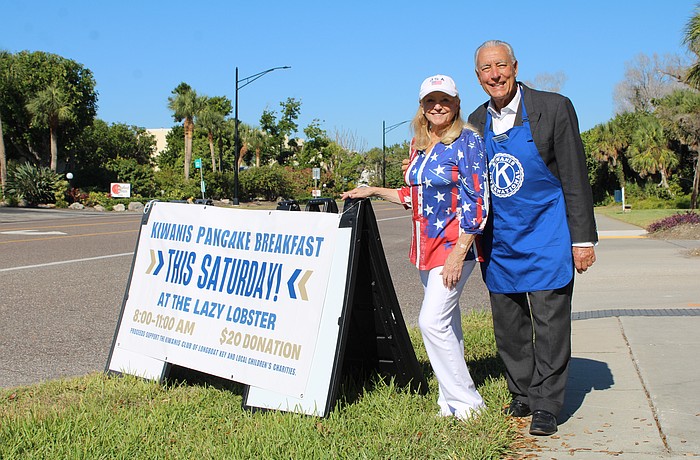 Phyllis Black and Andrew Vac flag down hungry diners to join the Kiwanis Club of Longboat Key's pancake breakfast fundraiser on Nov. 15 at the Lazy Lobster.