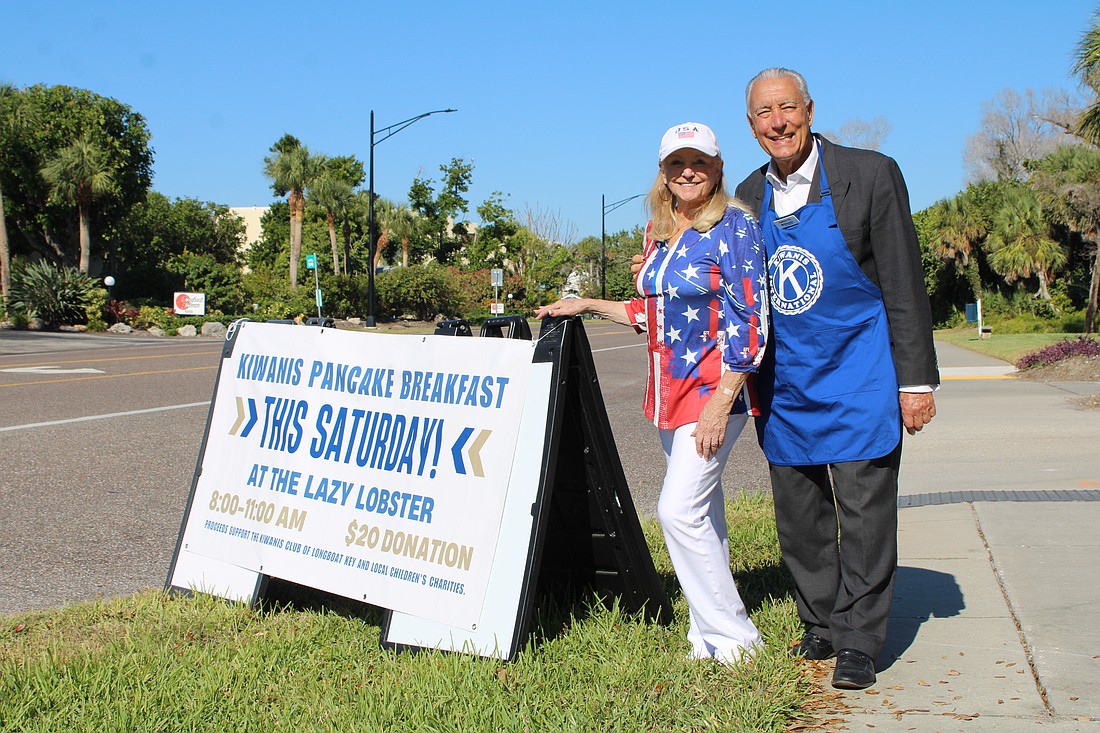 Phyllis Black and Andrew Vac flag down hungry diners to join the Kiwanis Club of Longboat Key's pancake breakfast fundraiser on Nov. 15 at the Lazy Lobster.