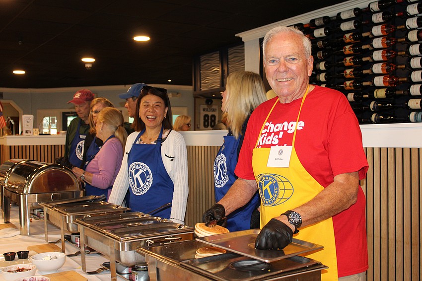 Bill Totten, a veteran pancake flipper with the Kiwanis Club of Longboat Key, dishes up hotcakes with fellow volunteers at the club's annual fundraiser on Nov. 15 at the Lazy Lobster.