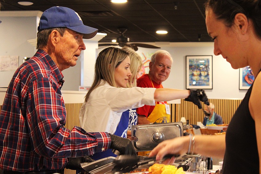 Jim Larson keeps the breakfast buffet line moving at the Kiwanis Club of Longboat Key's annual fundraiser on Nov. 15 at the Lazy Lobster.