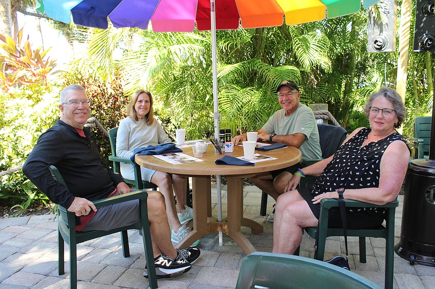 Bryan and Janet Barnard and Mike and Charlene Boettcher take their pancake breakfast plates outside. The Nov. 15 fundraiser at the Lazy Lobster benefited Family Promise of Sarasota-Manatee.