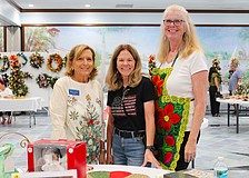 Elaine Cichon, Lorri Harrison and Claudia Stieber bring their festive spirit to the St. Mary, Star of the Sea, Catholic Church annual Christmas bazaar, held last weekend at the church.