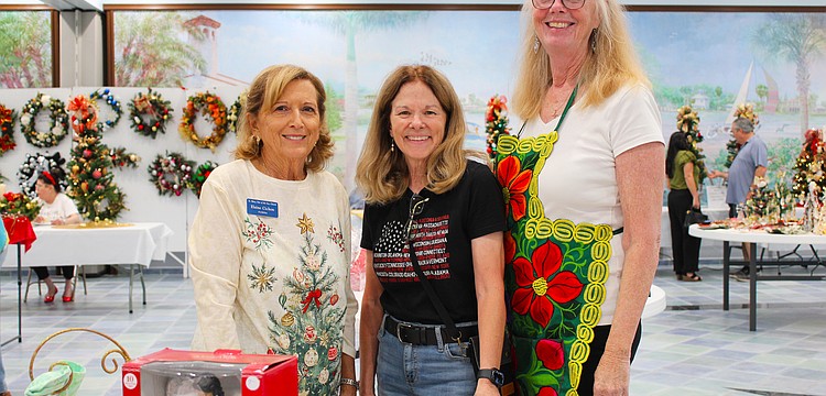 Elaine Cichon, Lorri Harrison and Claudia Stieber bring their festive spirit to the St. Mary, Star of the Sea, Catholic Church annual Christmas bazaar, held last weekend at the church.
