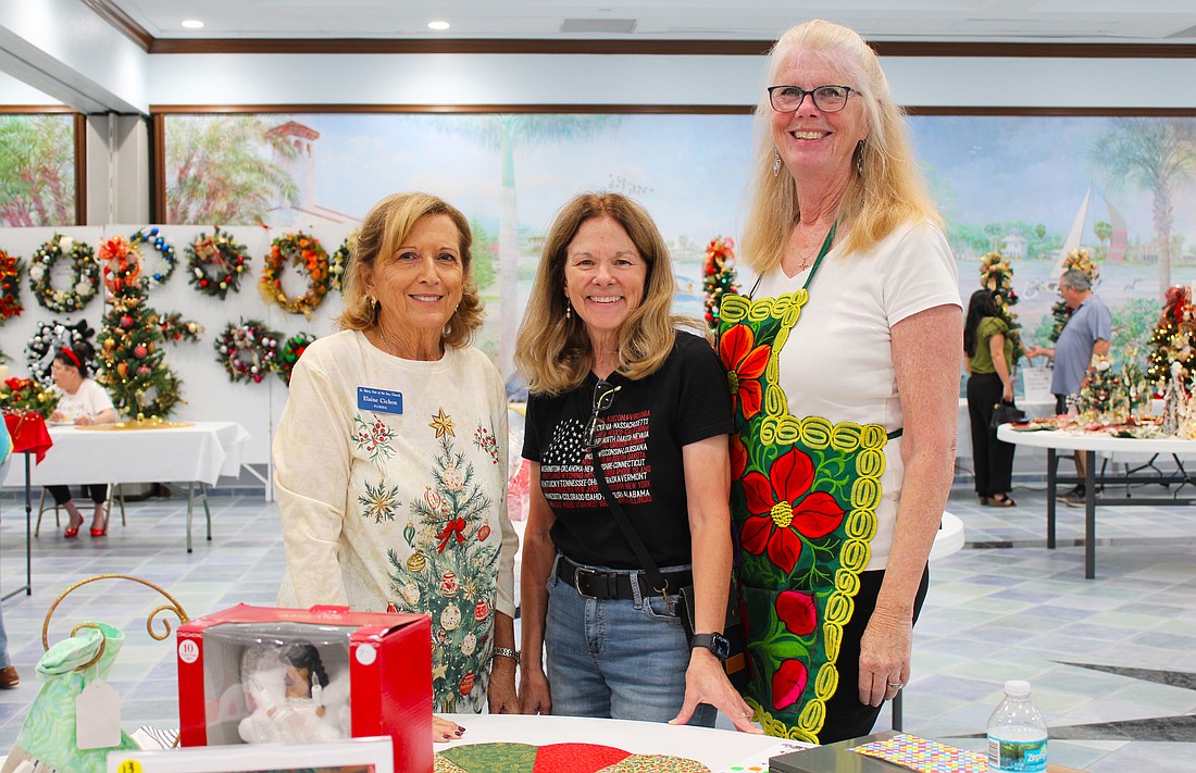 Elaine Cichon, Lorri Harrison and Claudia Stieber bring their festive spirit to the St. Mary, Star of the Sea, Catholic Church annual Christmas bazaar, held last weekend at the church.