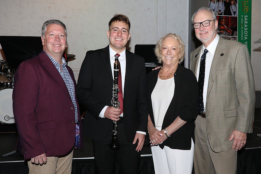 Rob Lambert and Michael Miller with Sherry and Tom Koski. Lambert has been the Youth Philharmonic Conductor for 15 years and coached now alum Miller.