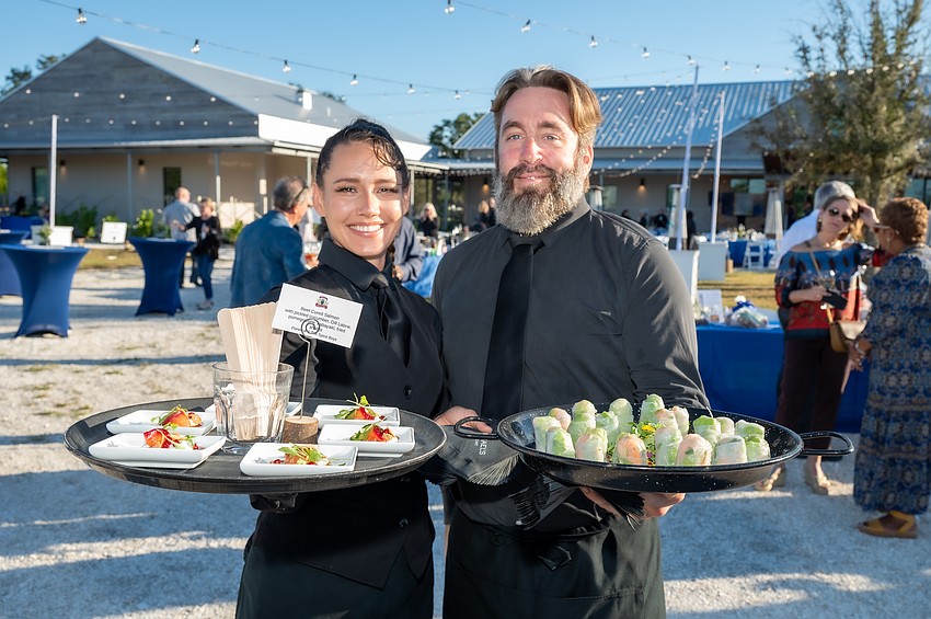 Ginger Davis with a Florence and the Spice Boys appetizer and Chas Miller with a Michaels On East appetizer.