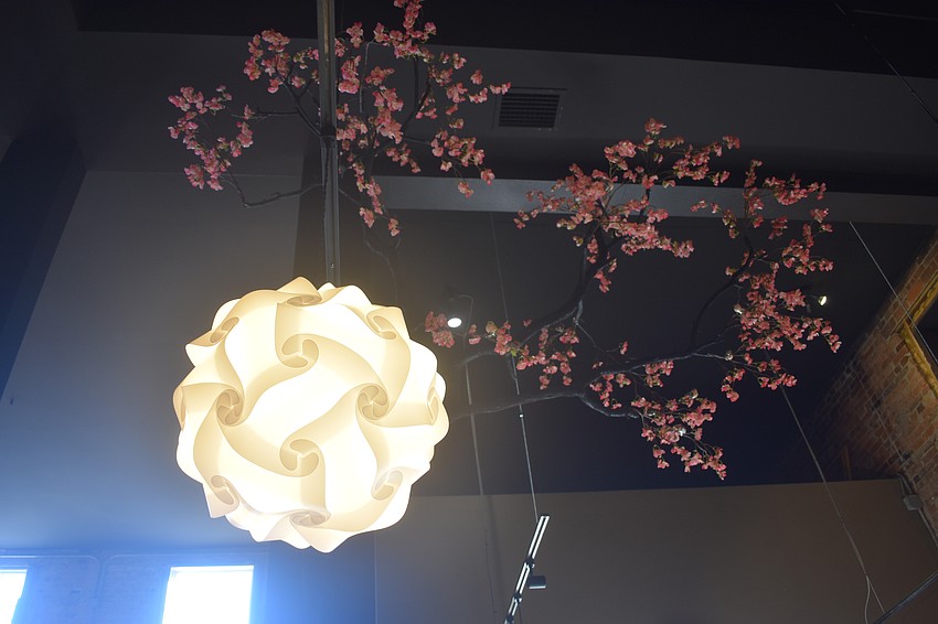 A sakura decoration hangs from the ceiling, along with a lantern.