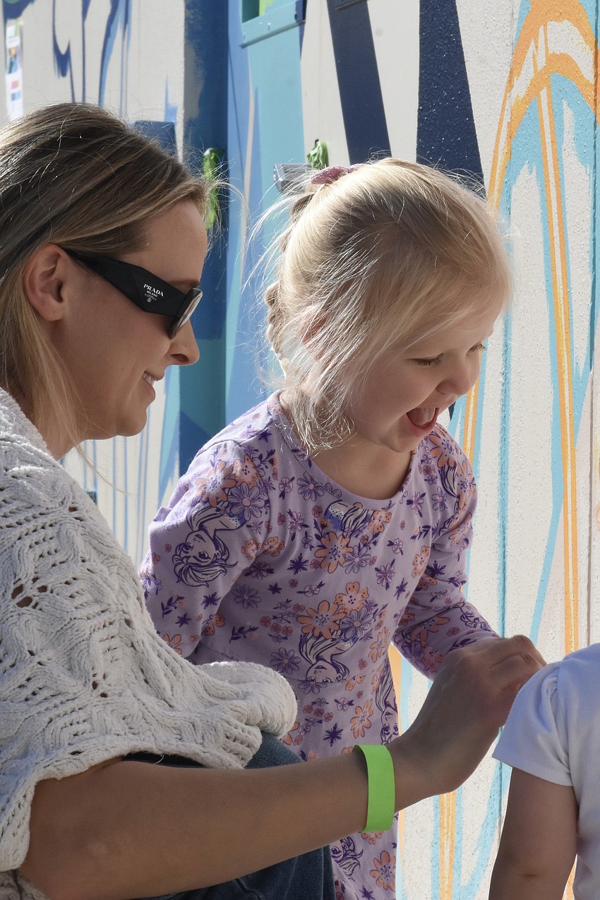 Jennifer Hazeltine and her daughter Scarlett Hazeltine, 3, arrive at the mural.