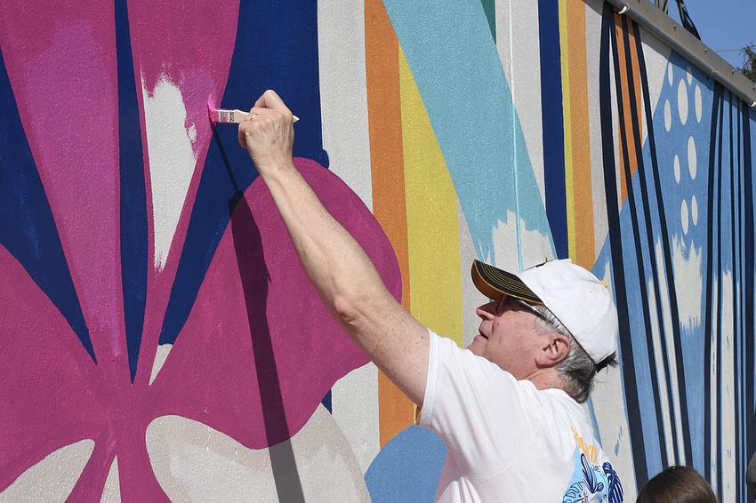 Steven Cover, director of planning with the City of Sarasota, paints the mural.