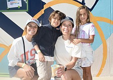 Sheena Works, Sebastian Works, 7, Alissa Silvers, and Isabella Coulton, 7, pose together in front of the mural.