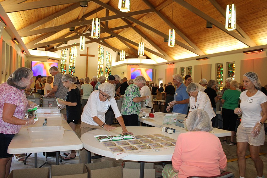Organizers packed as many tables as possible into the hall at St. Armands Key Lutheran Church for a recent food packing event. More than 120 volunteers lent a hand.