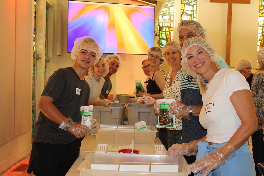 Jenny Minner brought the whole family to help out with the food packing event at St. Armands Key Lutheran Church on Nov. 8.
