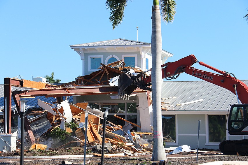 The Bird Key Yacht Club clubhouse entrance tumbles down on demolition day, making way for the new facility.