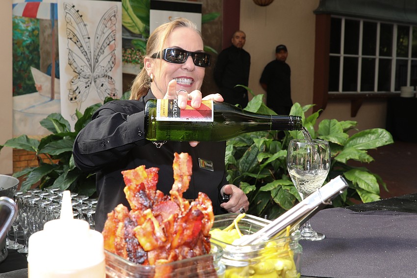 Eileena Roth serves at the wine pouring station.