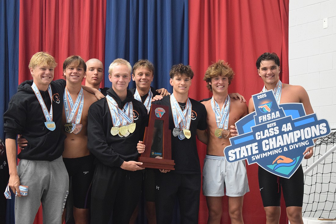 Sarasota boys' swimming poses for a photo on Nov. 14 at Florida Aquatics Swimming and Training in Ocala after winning the title. From left: Cy Matteson, Jackson Irwin, Adam Malaj, Bogdan Zverev, Daniil Siutsou, Daniel Keegan, Jack Sallee and Andrew Malaj (Charles Shoemaker not pictured).