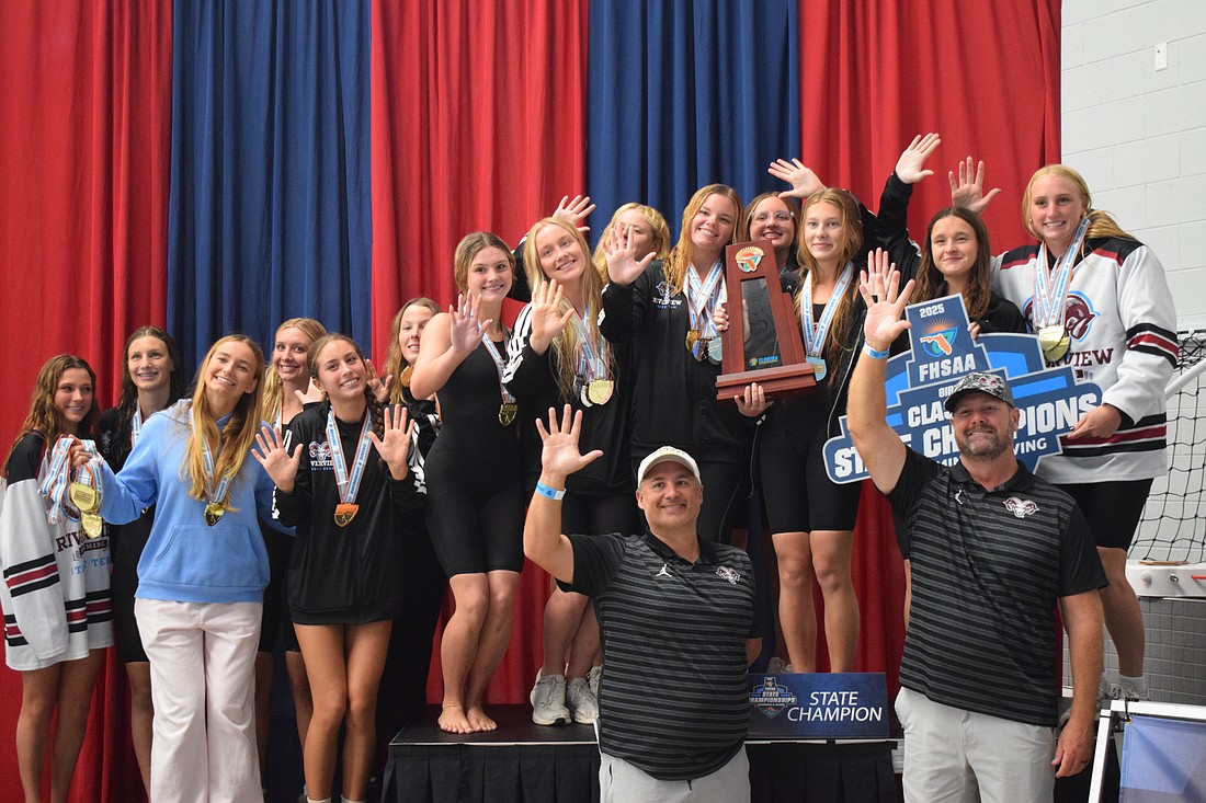 Members of Riverview girls' swimming put up five fingers representing their number of state titles since 2021. For the first time in program history, they've won five in a row.