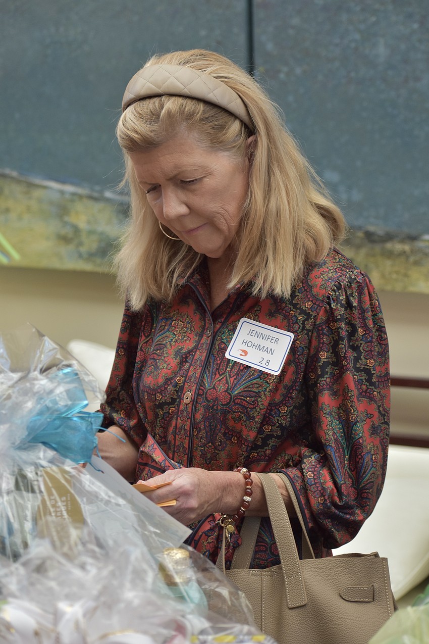 Jennifer Hohman places tickets with the raffle items.