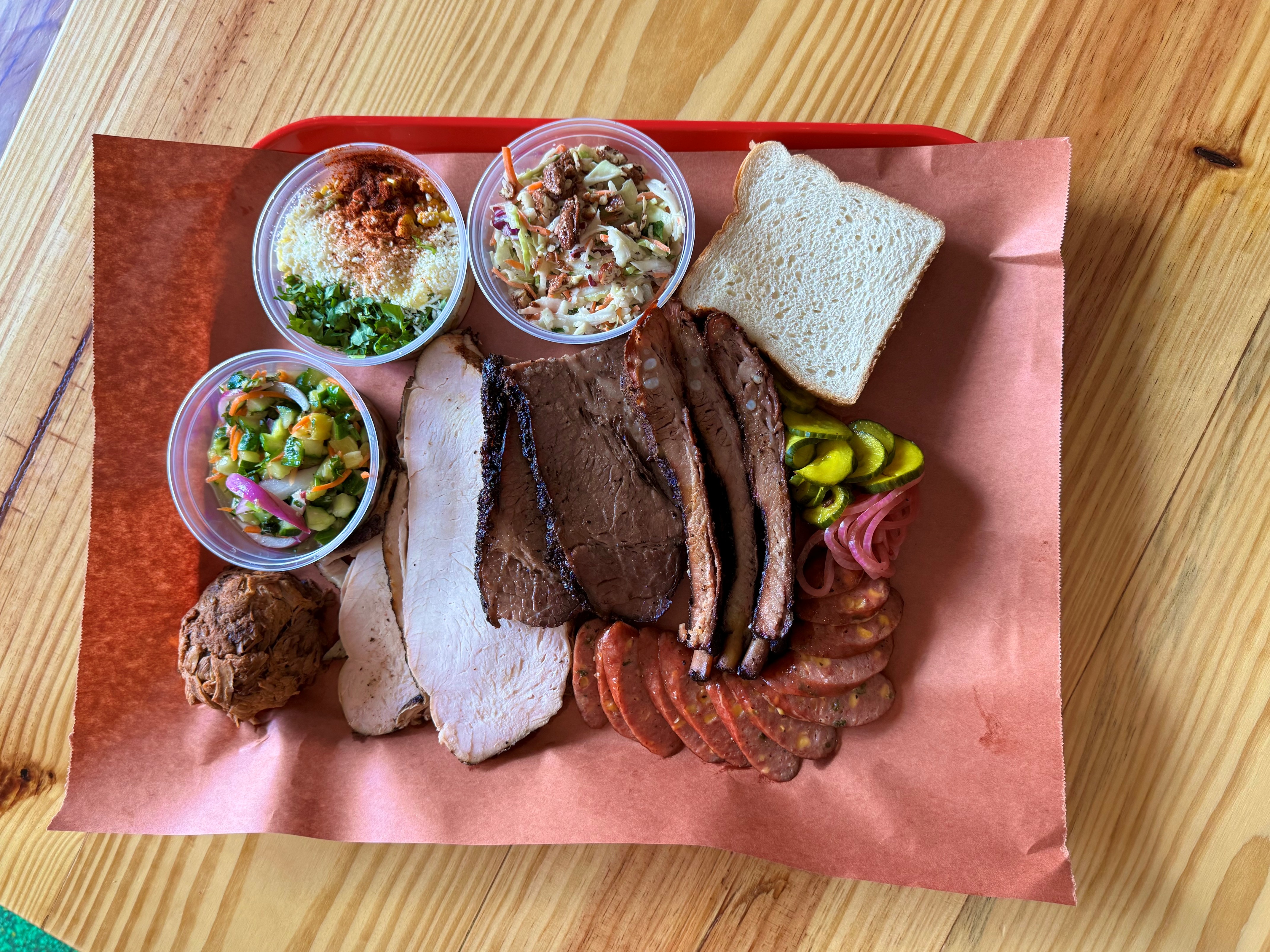 A sampler of Twisted Pit BBQ’s smoked specialties, including brisket, turkey, ribs and house-made sides. Chef Evan Percoco says patience is the first ingredient 
in every recipe.