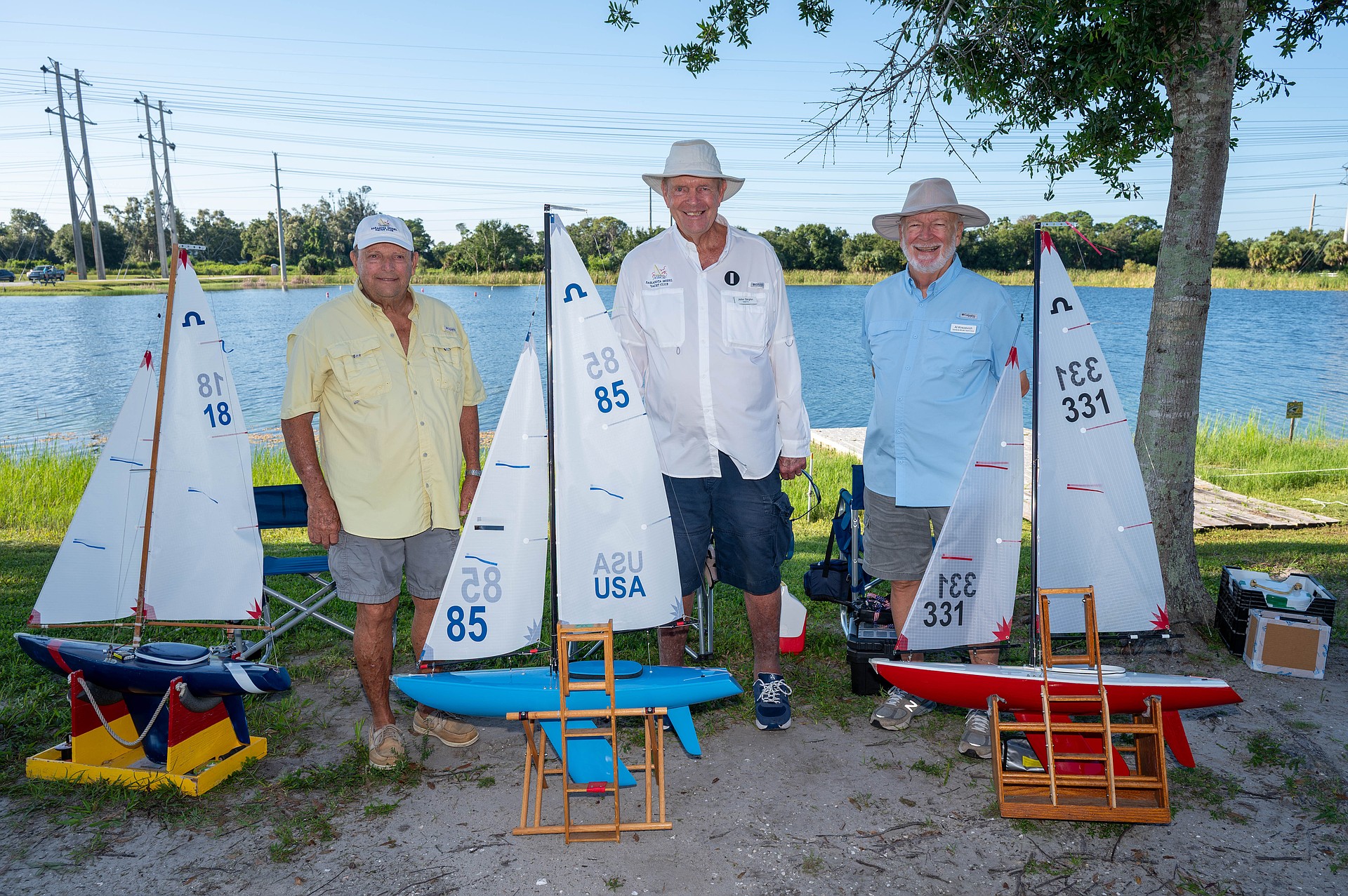 Bill Schmeising, John Stryhn and Al Knezevich display their radio-controlled Soling 1-Meter yachts at Nathan Benderson Park’s Green Parrot Lake.