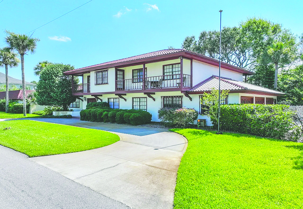 Corner lot home built in 1973 features six bedrooms, four bathrooms, porches, patio, pool, guesthouse, sauna and three-car garage.