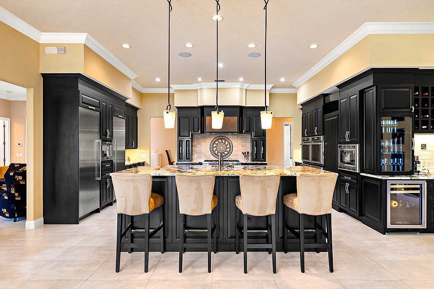Bold color choices enliven the home's expansive kitchen, with multiple prep countertops and seating areas.