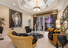 The formal living room boasts a striking painting of a rhino, acquired during a recent safari in South Africa.