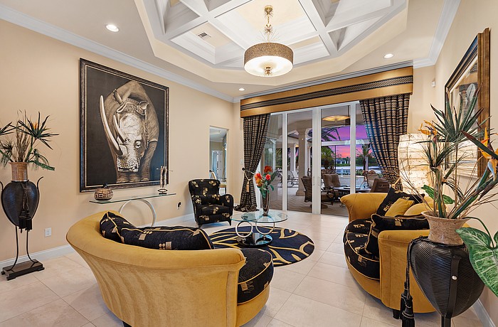 The formal living room boasts a striking painting of a rhino, acquired during a recent safari in South Africa.