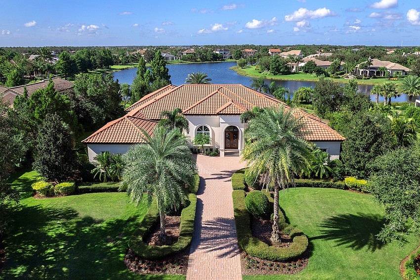 Long views over a tranquil lake add a special touch to this 5,000-square-foot home in the Tuscan-inspired community.