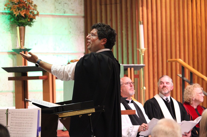 Michael Bodnyk, minister of music and director of operations at St. Armands Key Lutheran Church, leads the interfaith choir at the 45th annual Thanksgiving service on Nov. 18 at the church.