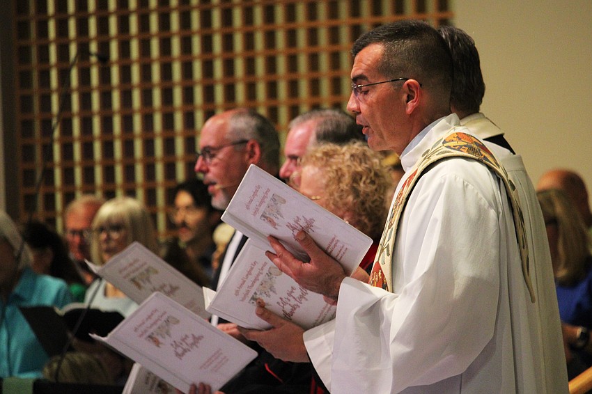St. Mary, Star of the Sea, Catholic Church's Fr. Robert Dziedziak joins in singing the hymn 