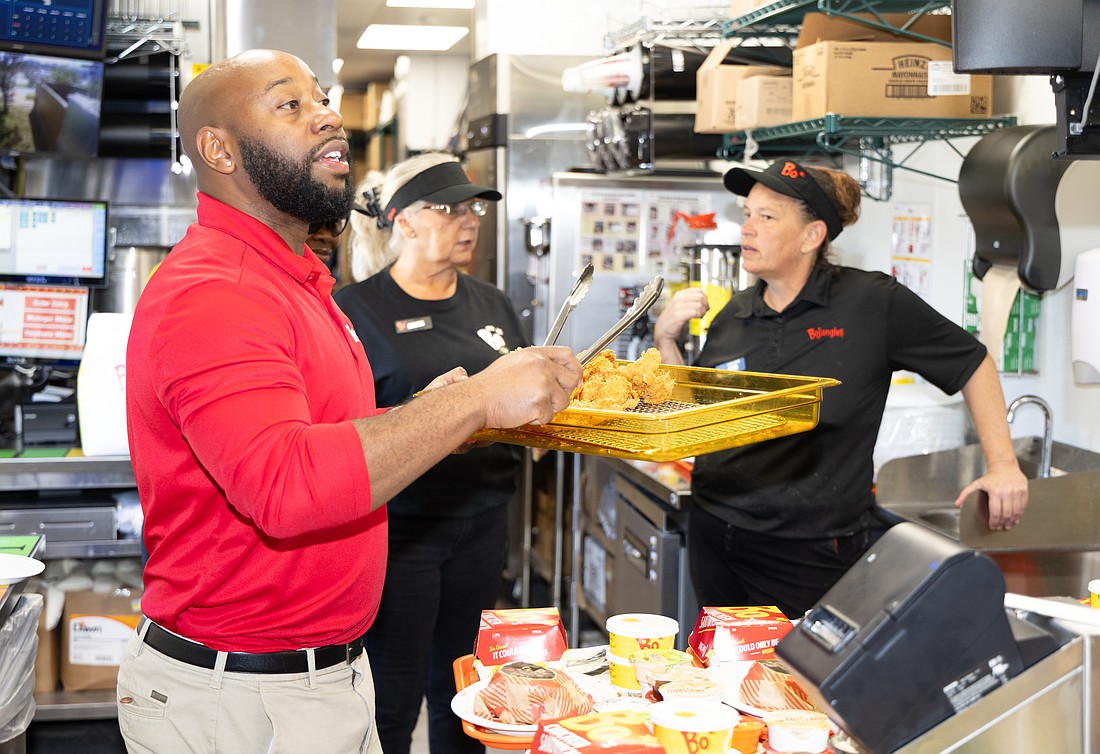 Bojangles employees prepare to deliver menu samples to those who attended a pre-opening day party at the chain's new Pinellas Park restaurant Nov. 3.
